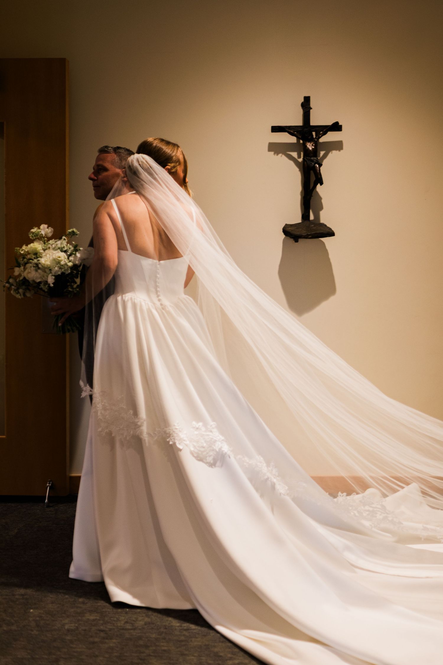 A flowing white wedding dress with a dramatic long train photographed in a series of artistic angles.