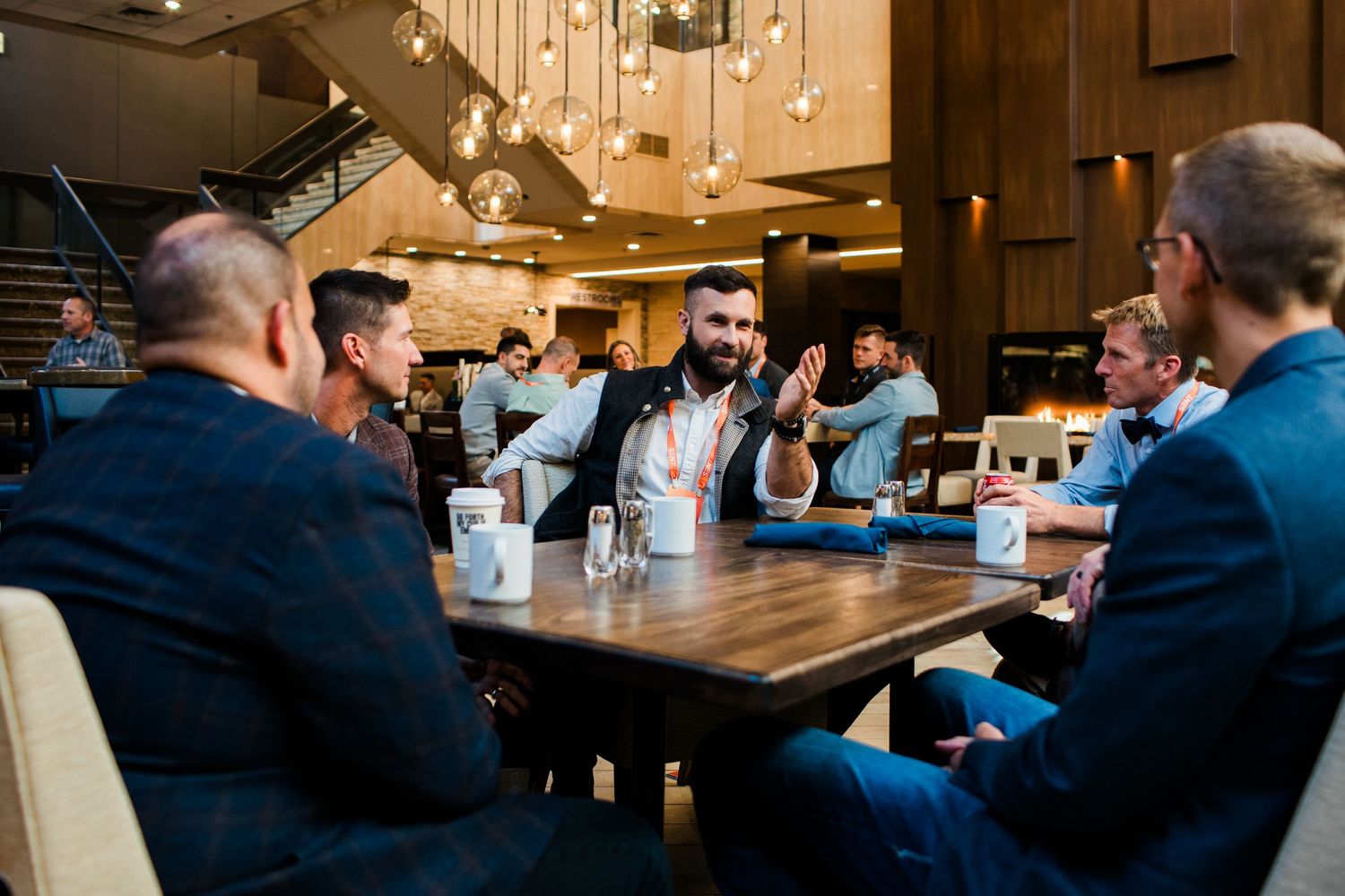 Business professionals networking at a modern restaurant during a corporate dinner meeting event.
