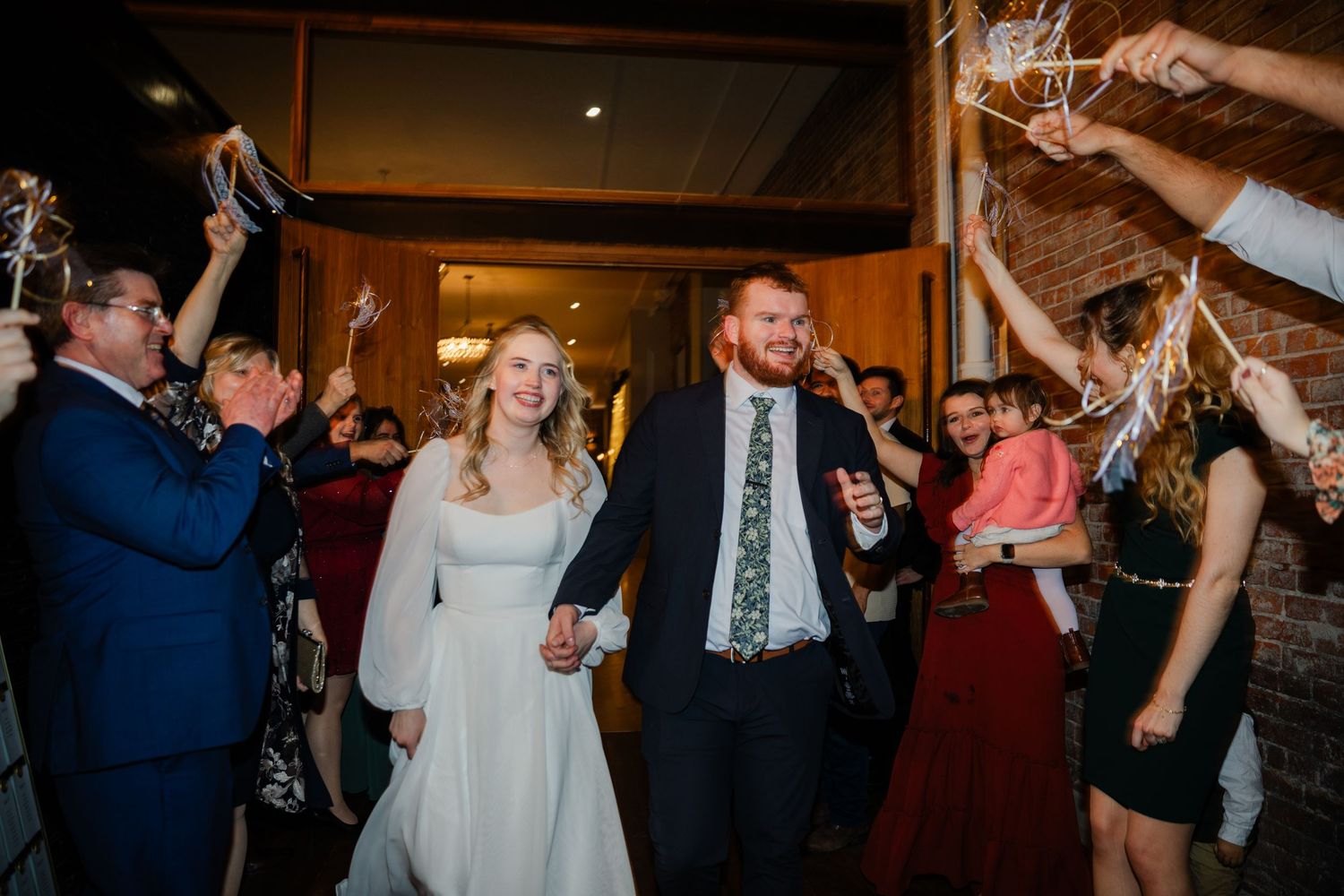 Wedding reception dance floor scenes with guests celebrating under warm lighting.