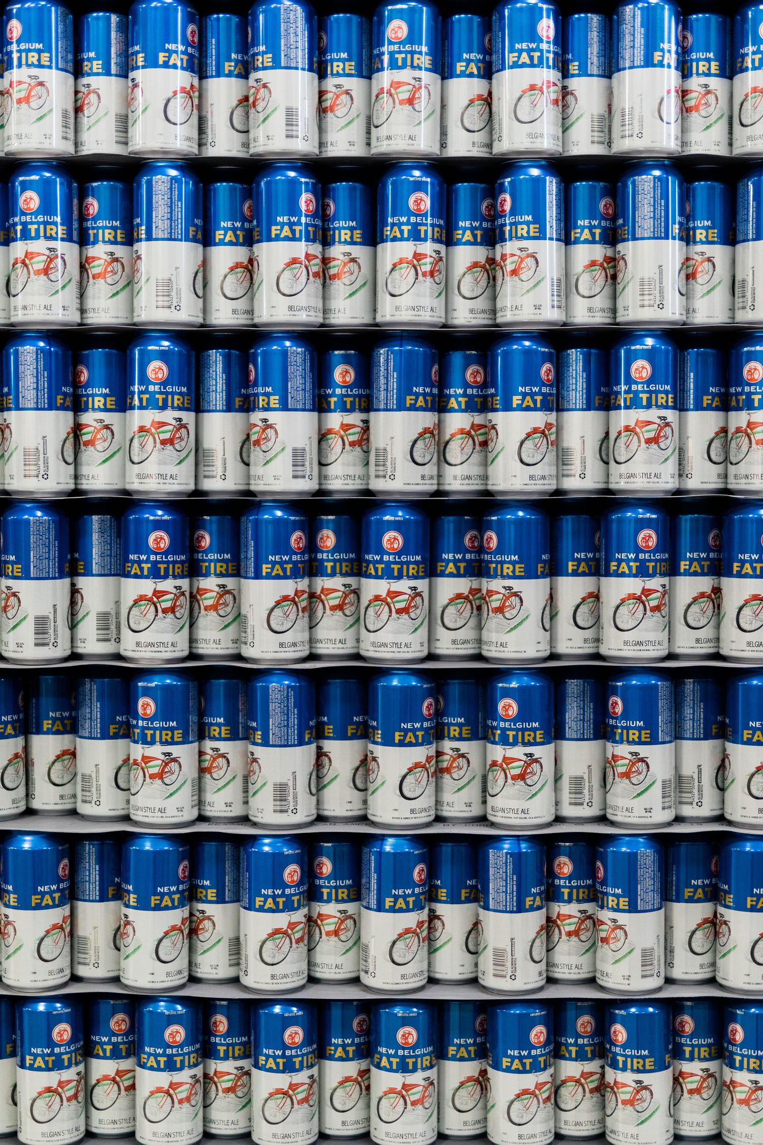 Rows of stacked Pepsi and Diet Pepsi aluminum cans arranged on retail shelves creating a blue and silver pattern.