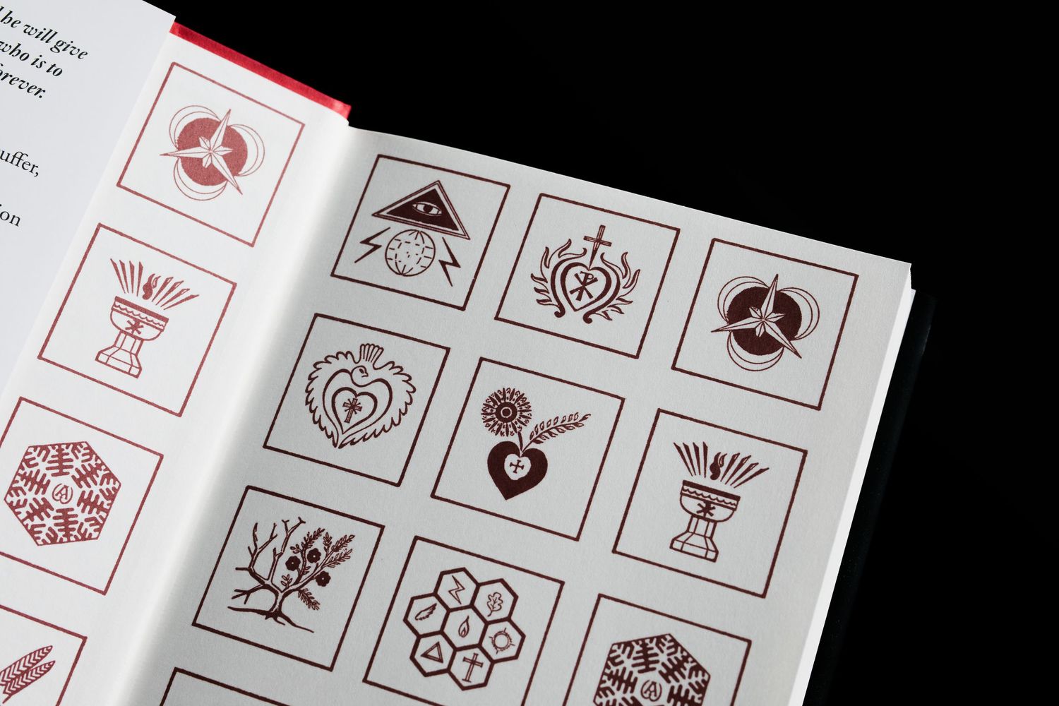 Open book displaying a grid of decorative religious symbols and icons in red and white illustrations.