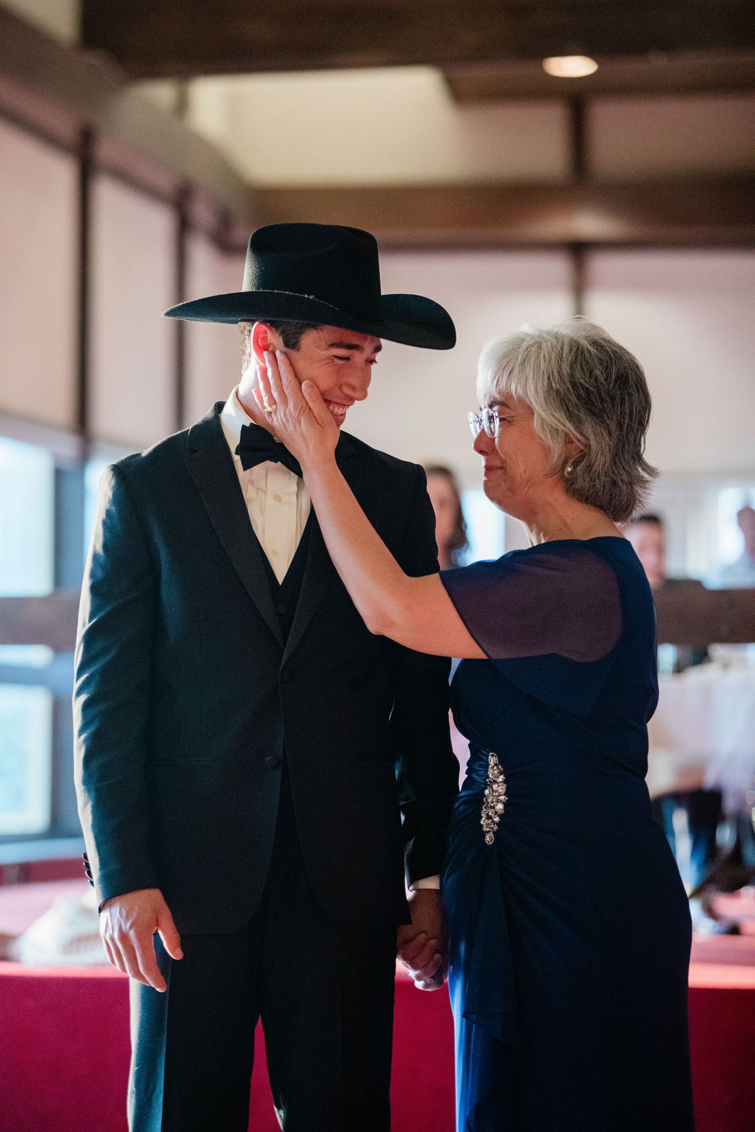 Dance sequence showing partners in formal attire including a black cowboy hat sharing an intimate moment.