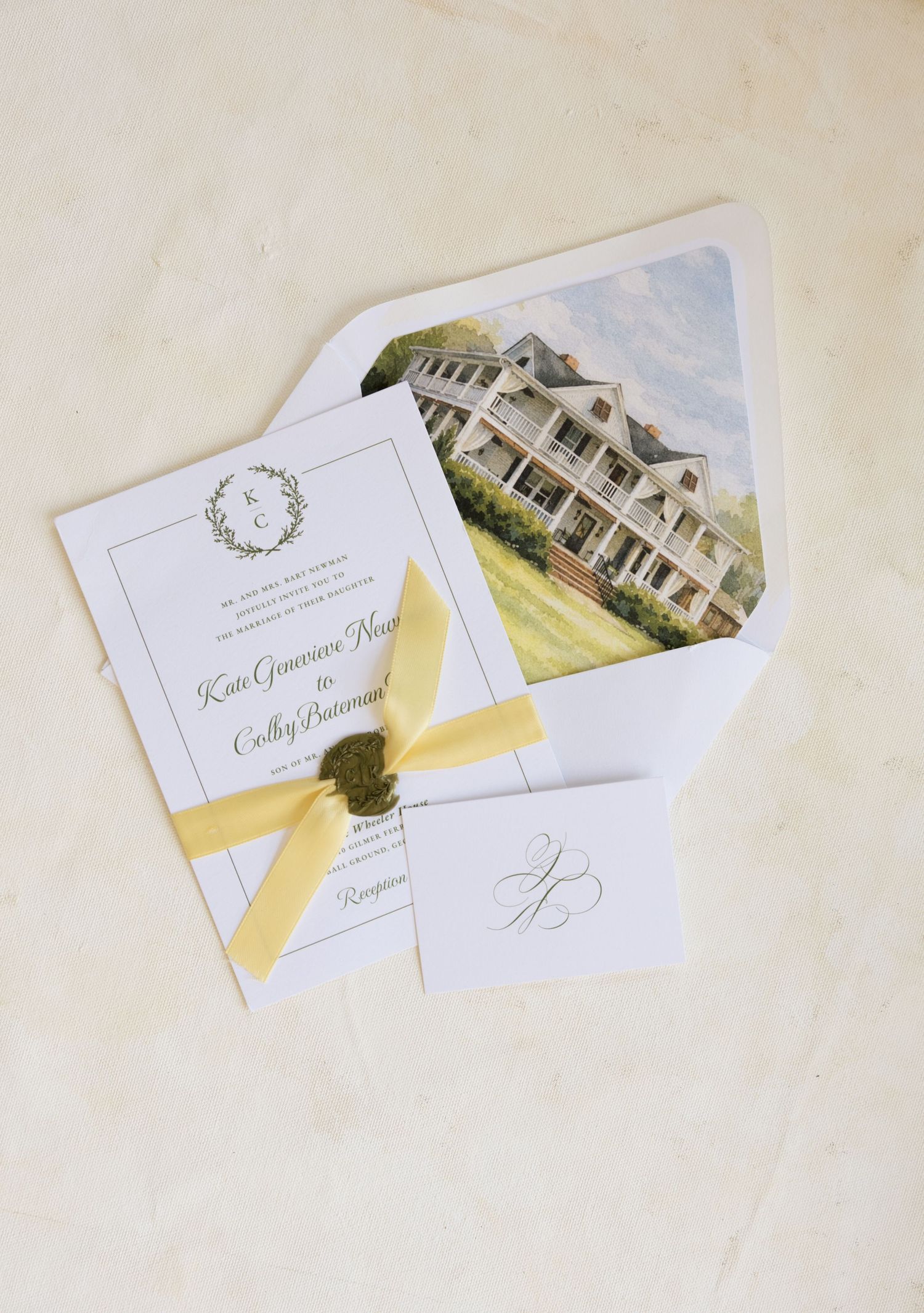 Elegant wedding invitation suite with yellow ribbon, wax seal, and watercolor venue illustration inside envelope liner.