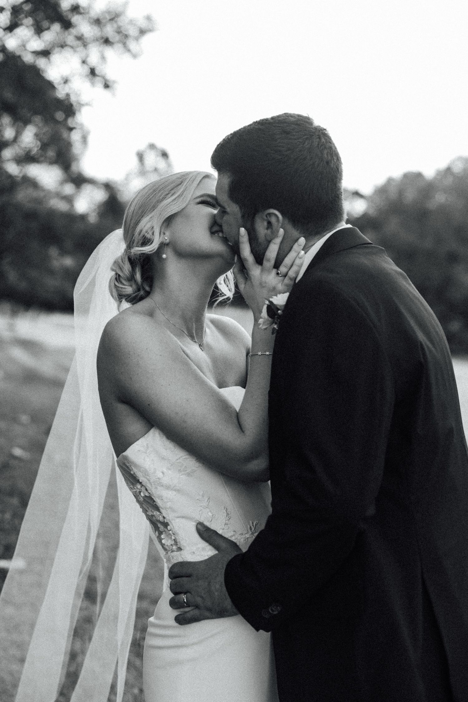 Black and white romantic wedding portrait of couple sharing an intimate moment.
