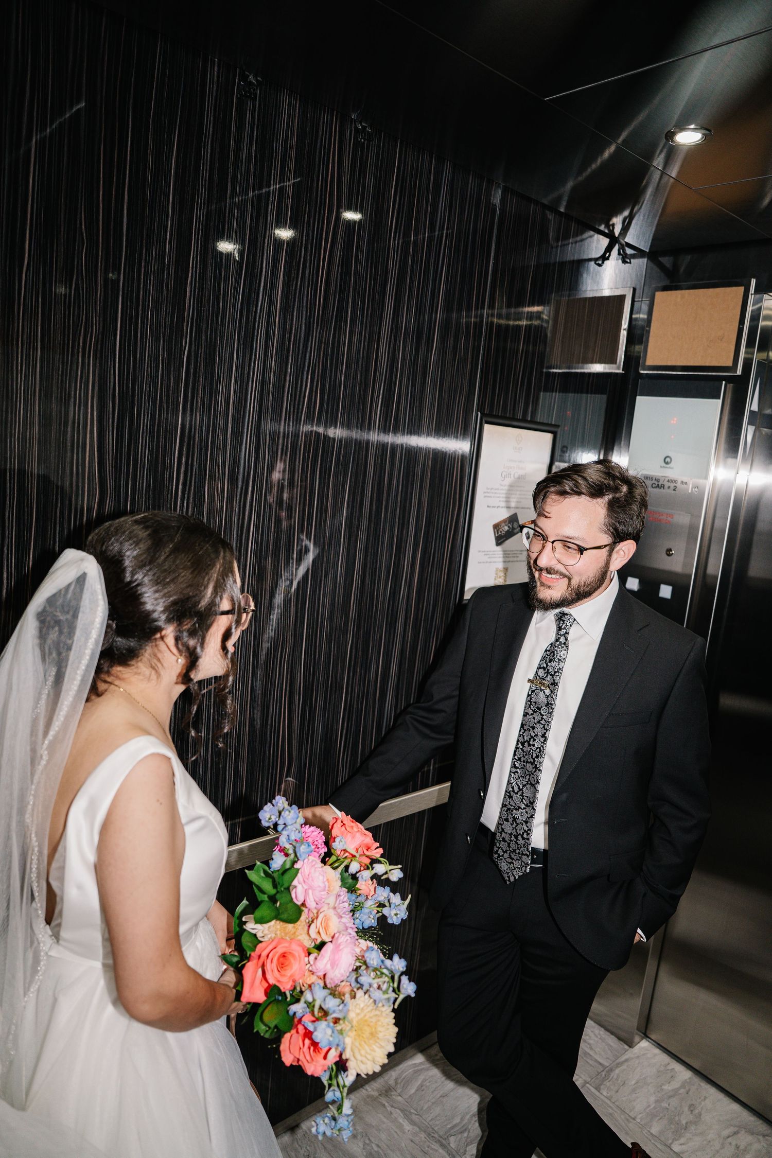 Wedding sequence showing couple sharing intimate moments in a dark hallway with colorful bouquet.