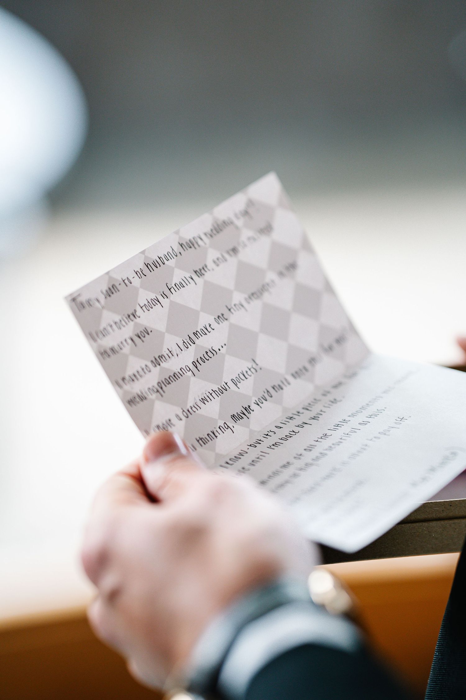 Multiple business cards being held and viewed in sequence with shallow depth of field.
