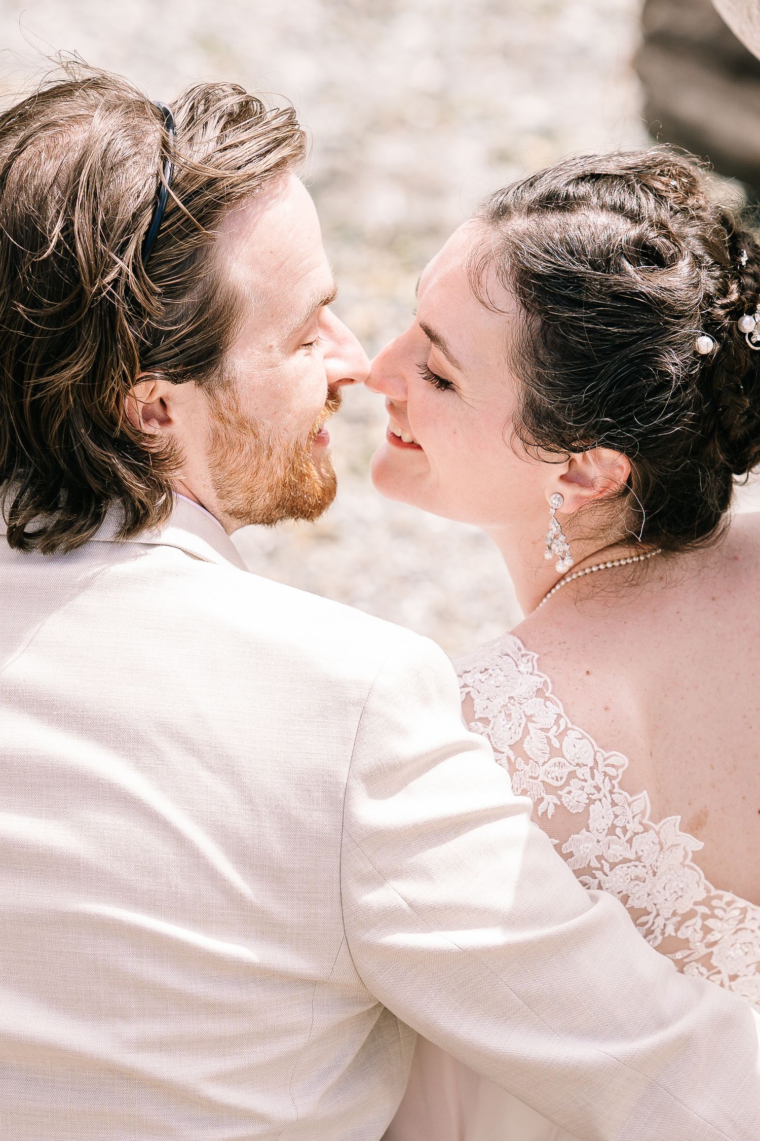 A romantic sequence of wedding photos showing a couple in white embracing and sharing tender moments together.