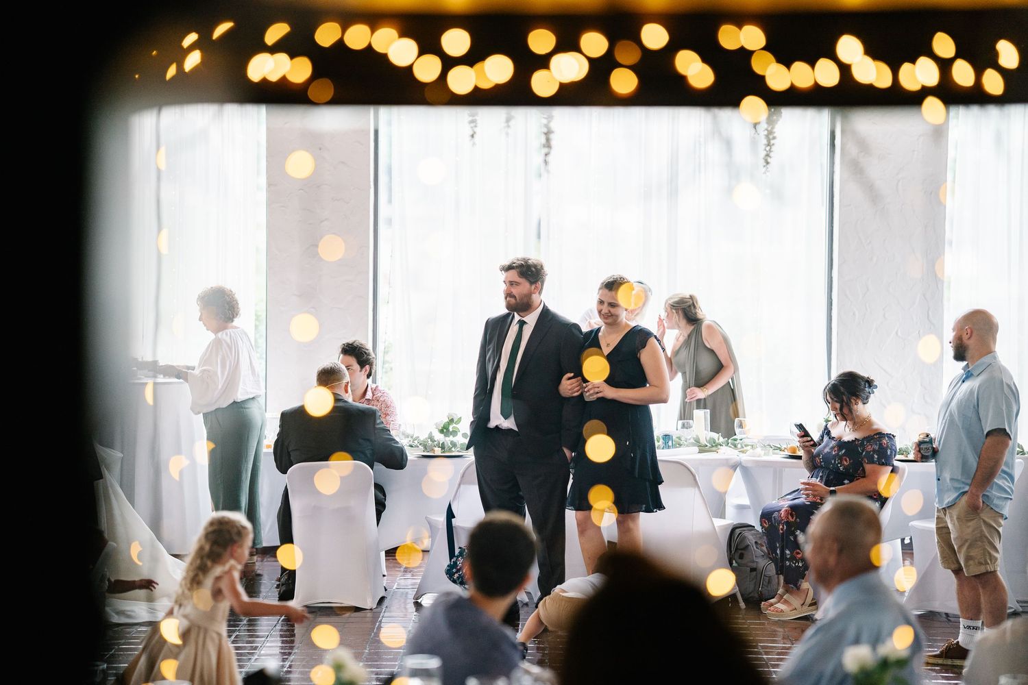 A sequence of photos showing people mingling at an event with warm lighting and modern interior decor.