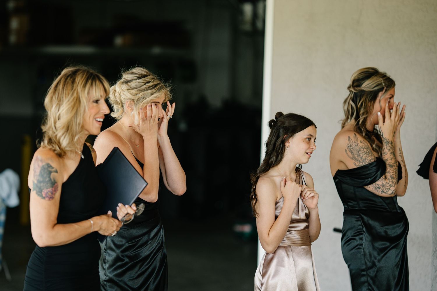A series of candid black and white photos showing tender moments between people at a wedding celebration.