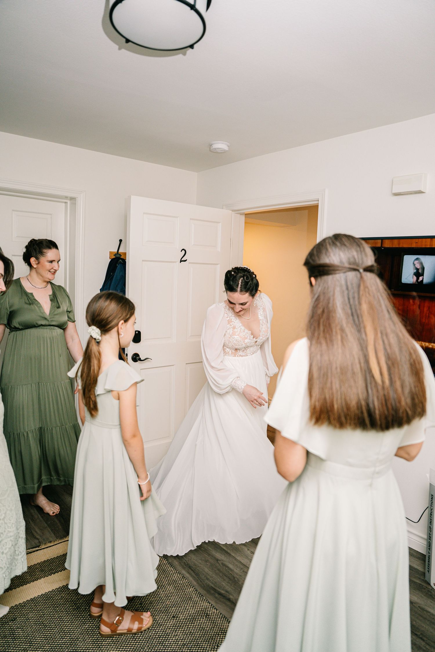 A series of indoor wedding preparation moments showing a white dress and people getting ready in a bright room.