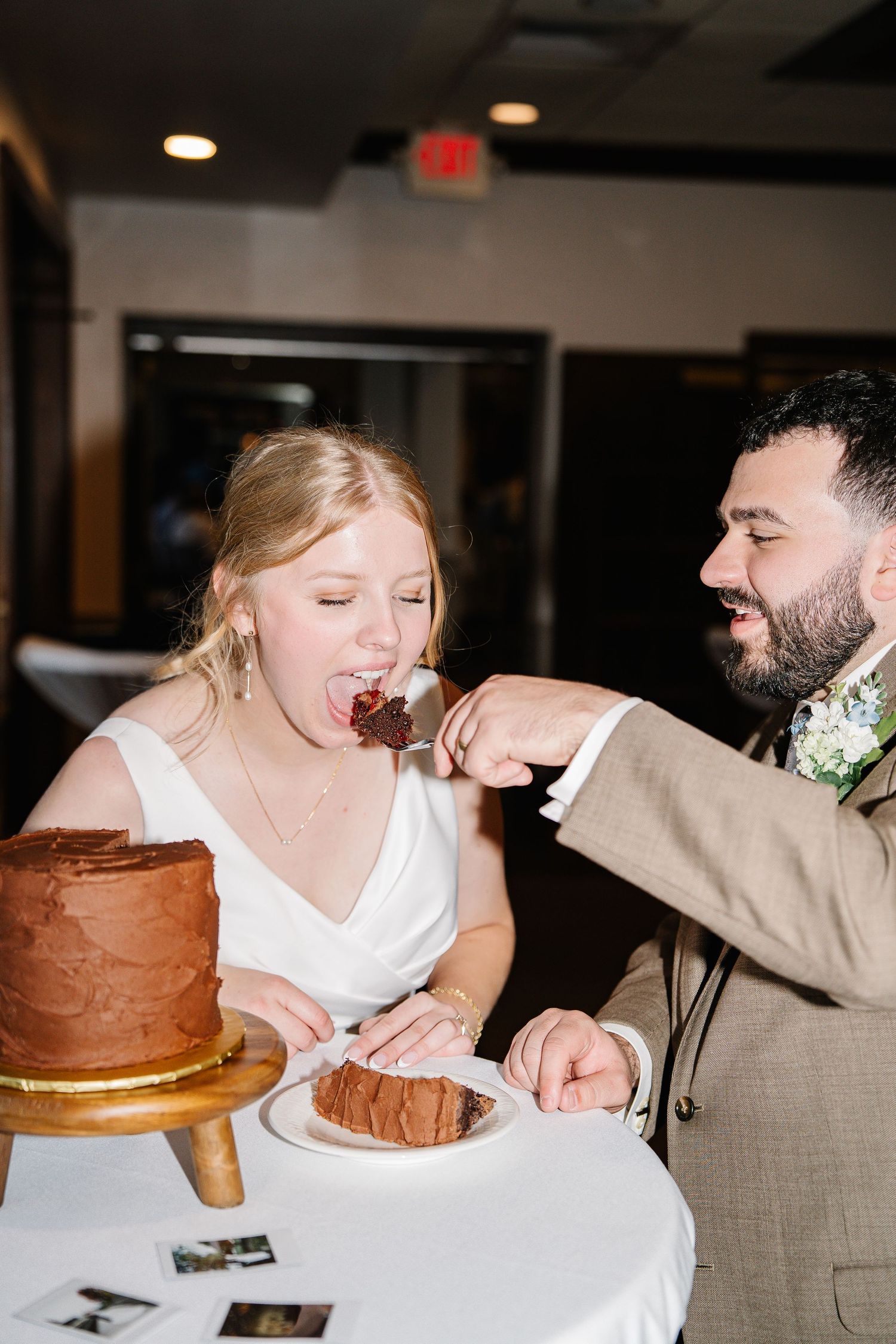 A sequence of four photos showing a couple playfully eating chocolate cake at what appears to be a wedding reception.