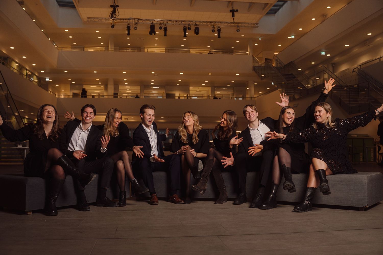 Group photo of business professionals arranged in a creative formation indoors.