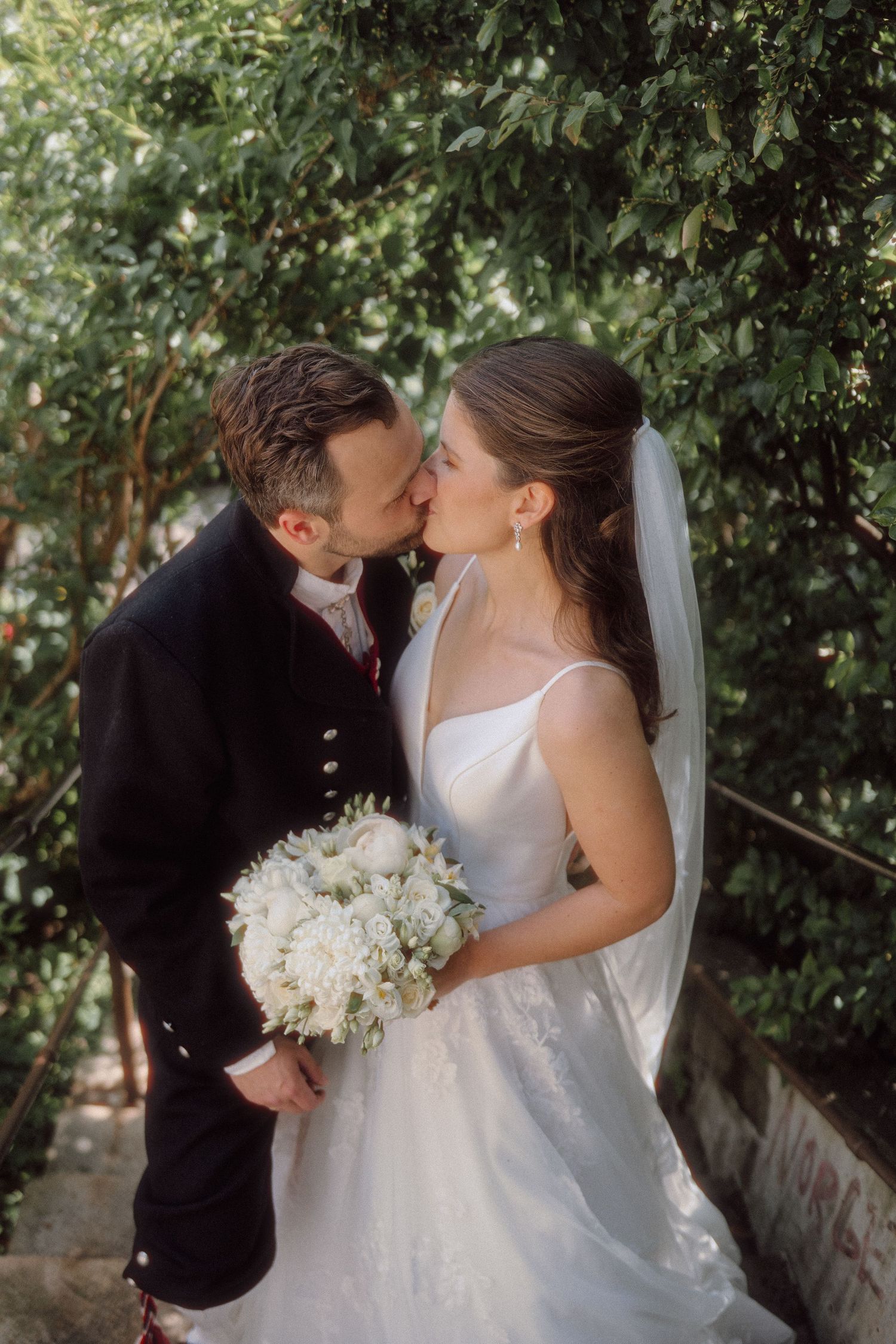 A romantic wedding photoshoot sequence in a garden setting with white floral bouquet.