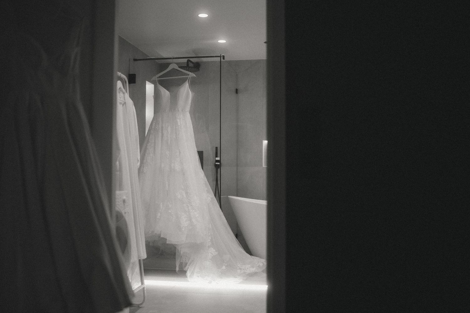 Dark interior shots showing wedding dress preparations in a dimly lit room.