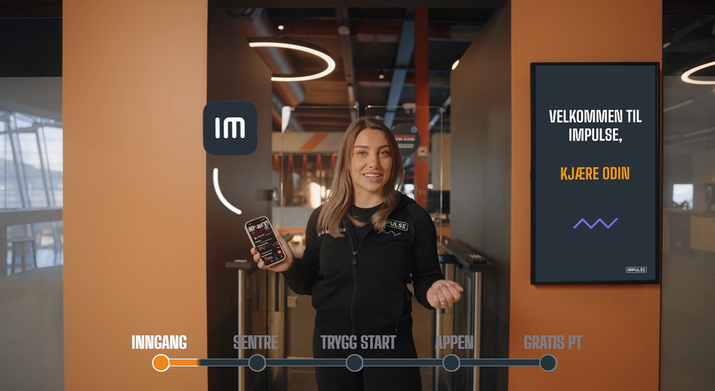 Corporate office space with digital wall displays and modern lighting fixtures.