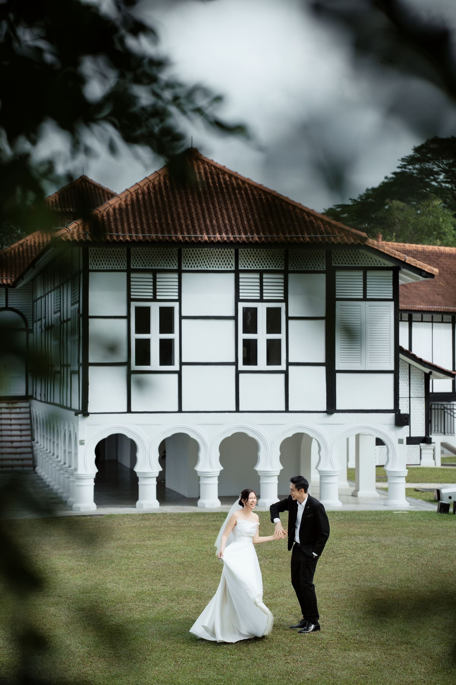 A sequence of wedding photos showing a couple posing in front of a colonial-style white building with dark trim and pillars.
