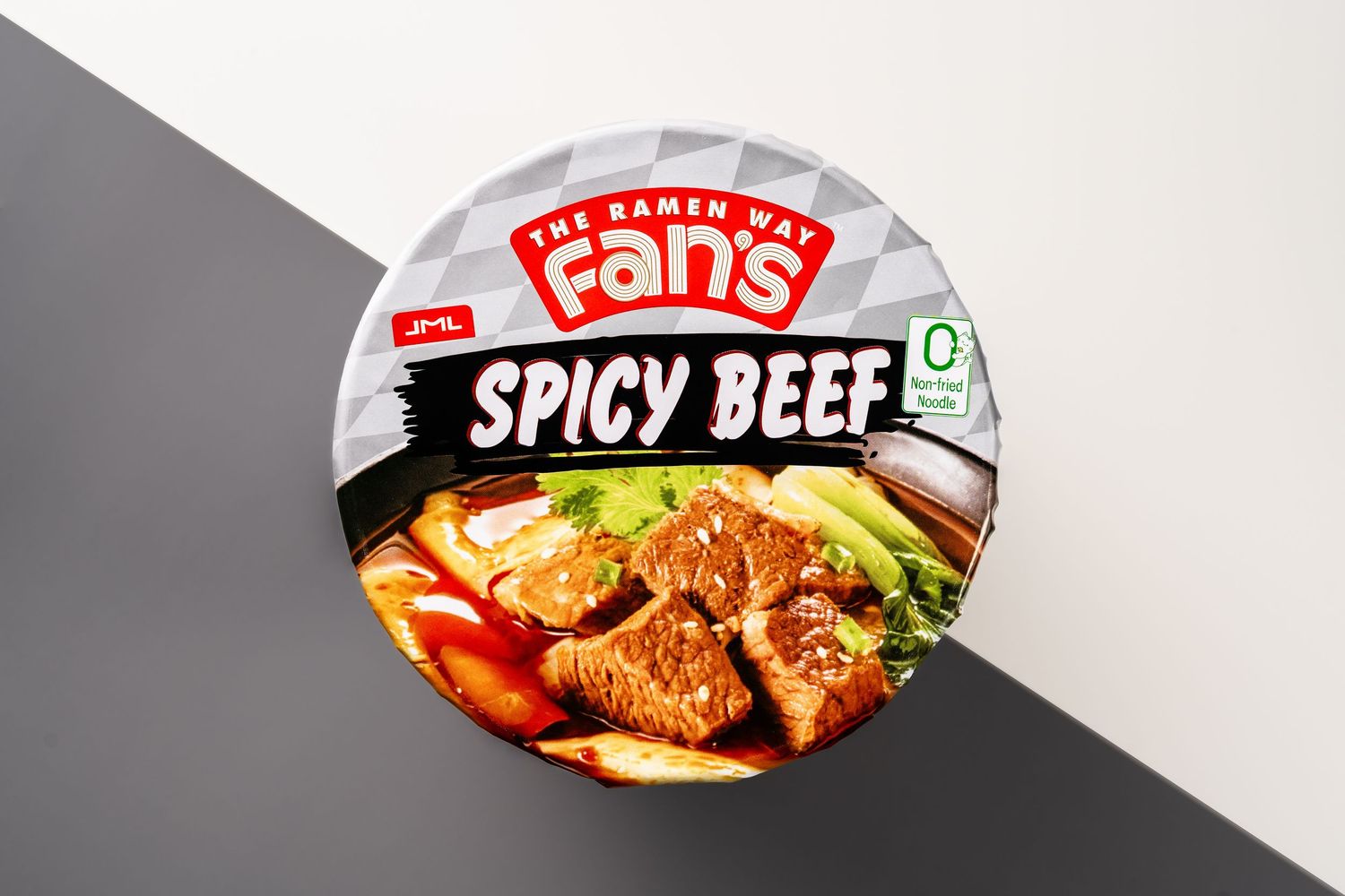 Fan's Spicy Beef ramen cup noodles with savory broth, tender beef slices, and fresh vegetables on display.