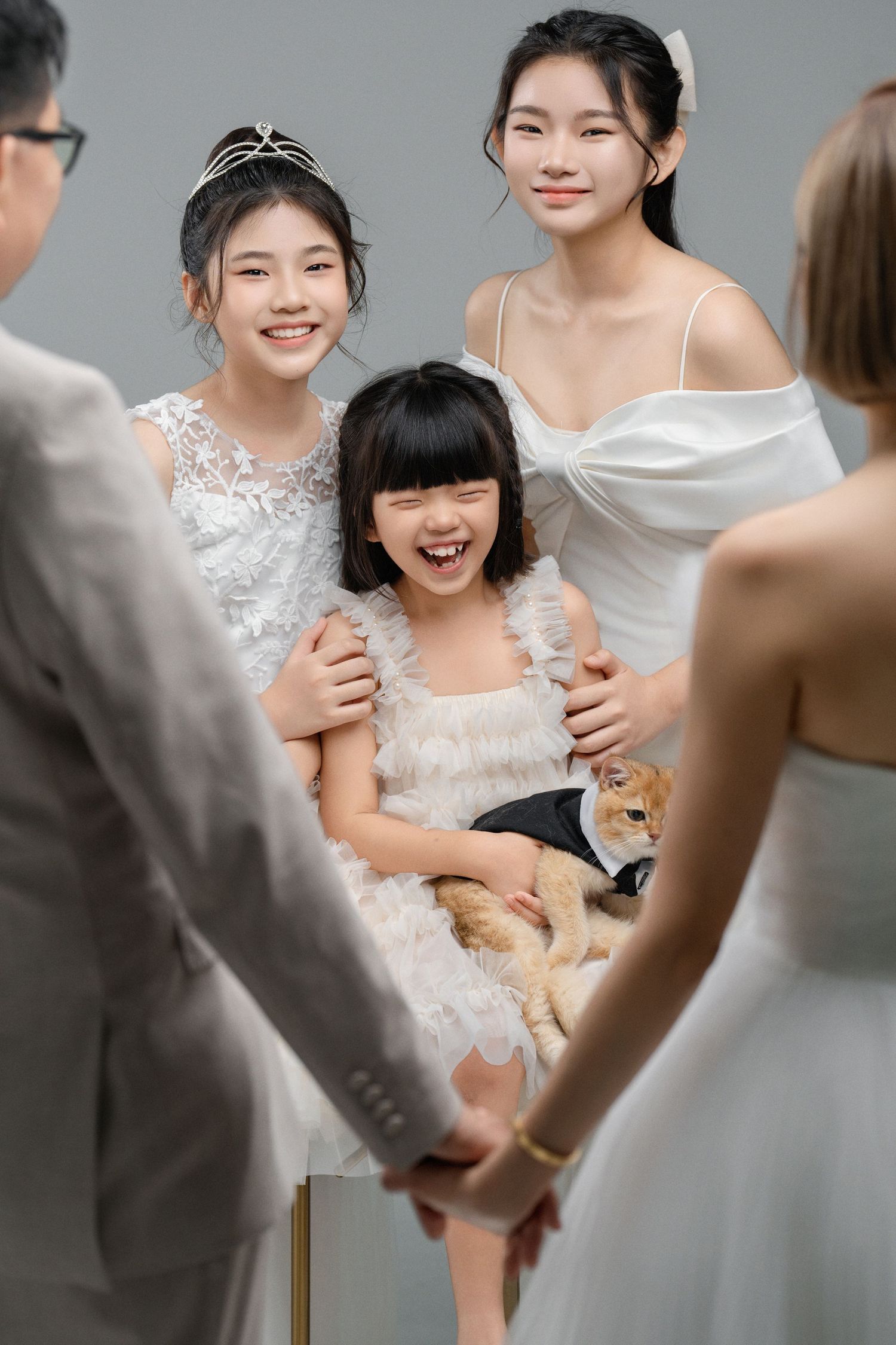 A series of photos showing a young person in a white dress sitting and laughing during a joyful moment.