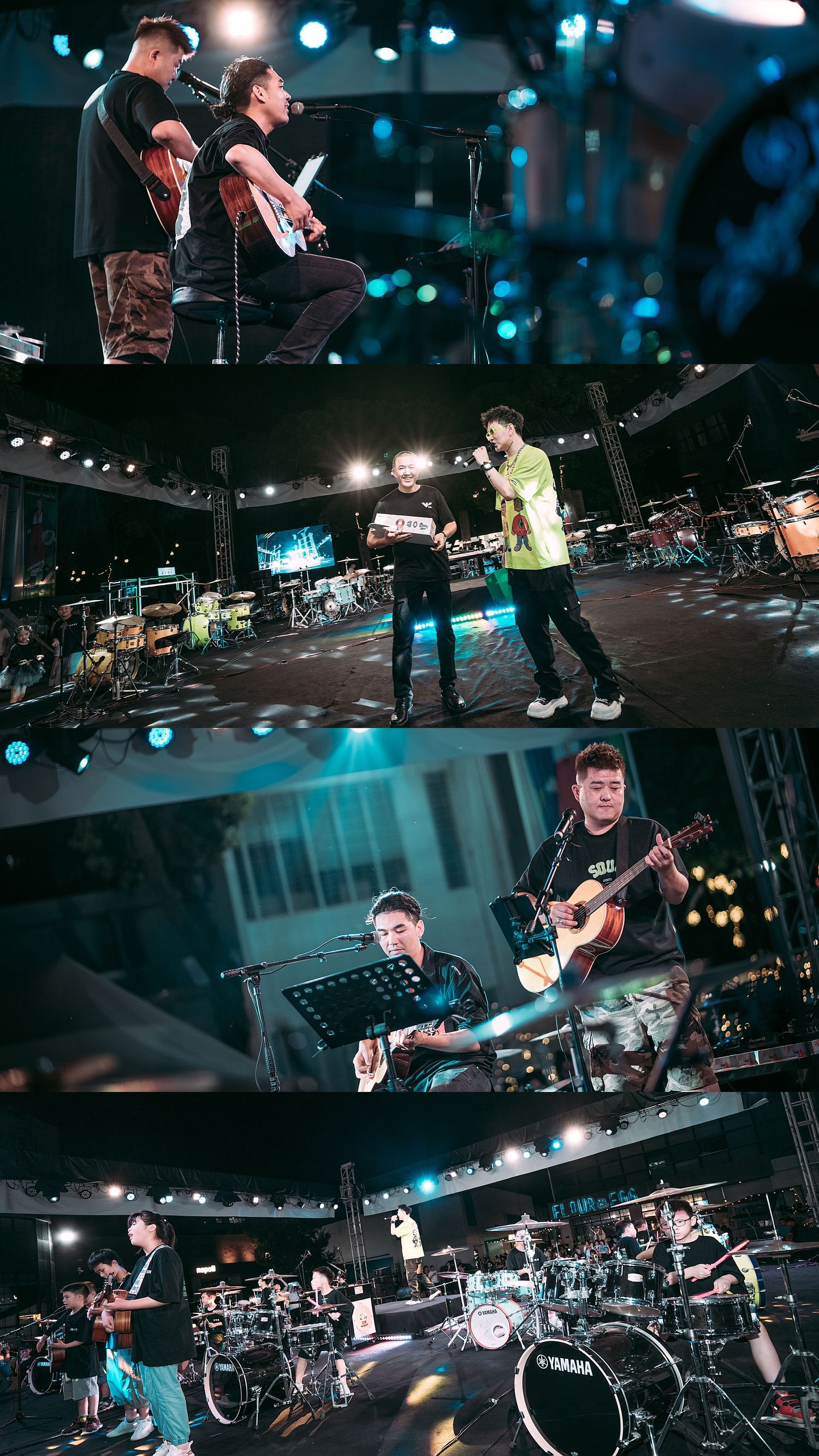 Musicians performing on a concert stage at night, playing electric and acoustic guitars with drums and stage lights visible.