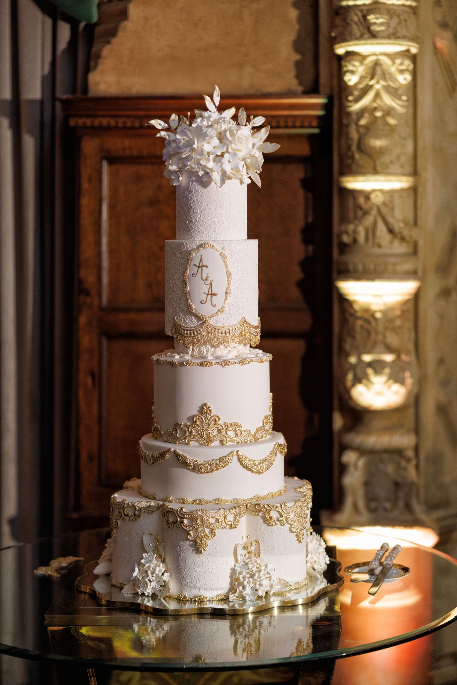 The statement cake, gleaming with regal gold accents.