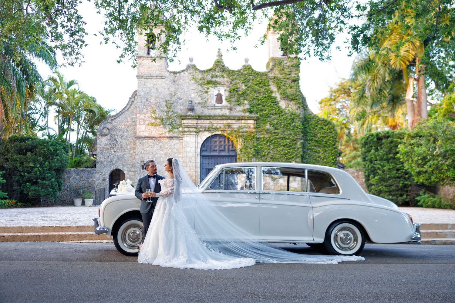 The newlyweds outside with their classic Rolls Royce.