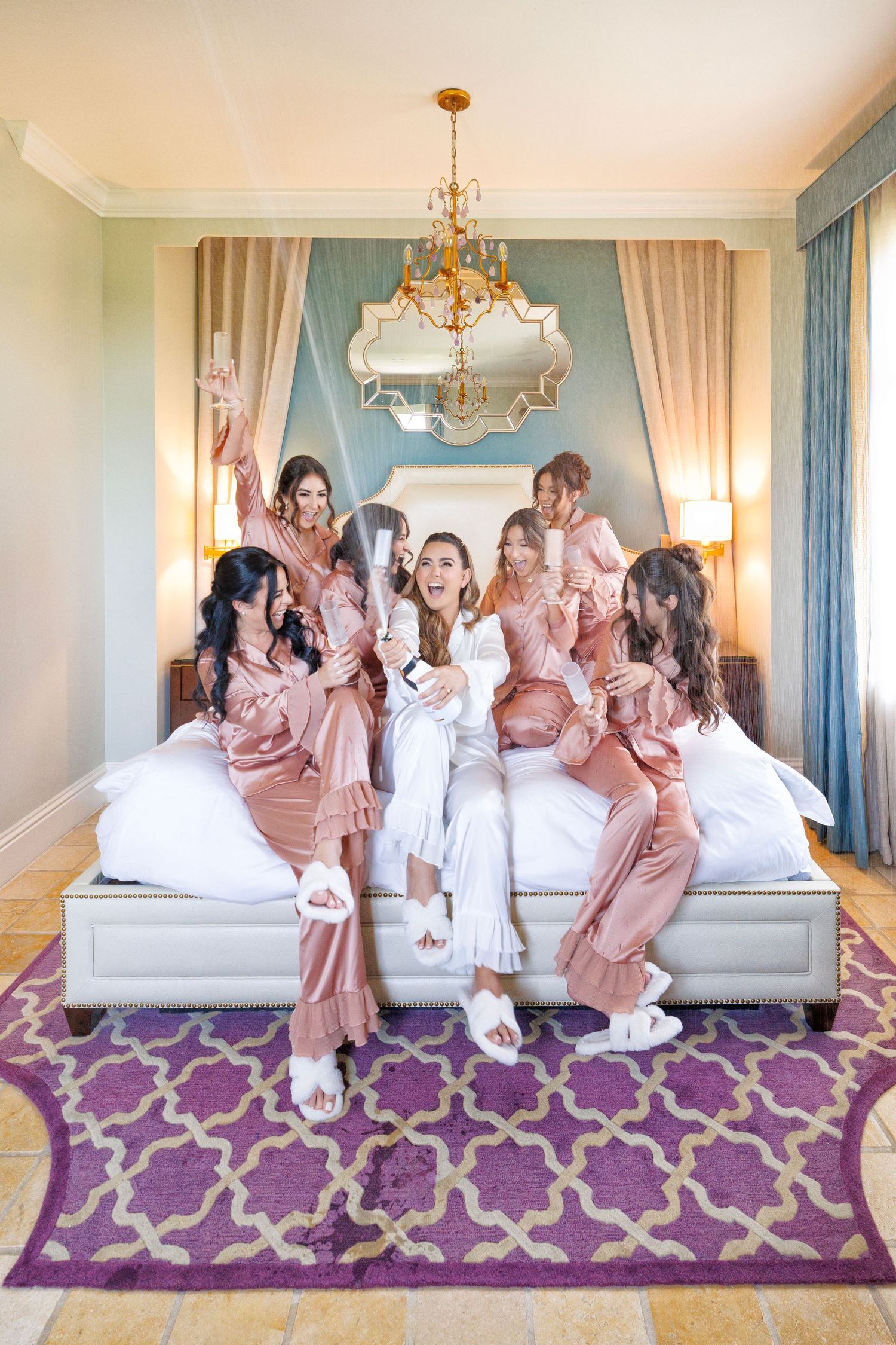 Bridesmaids in matching robes share laughs and excitement before the ceremony.