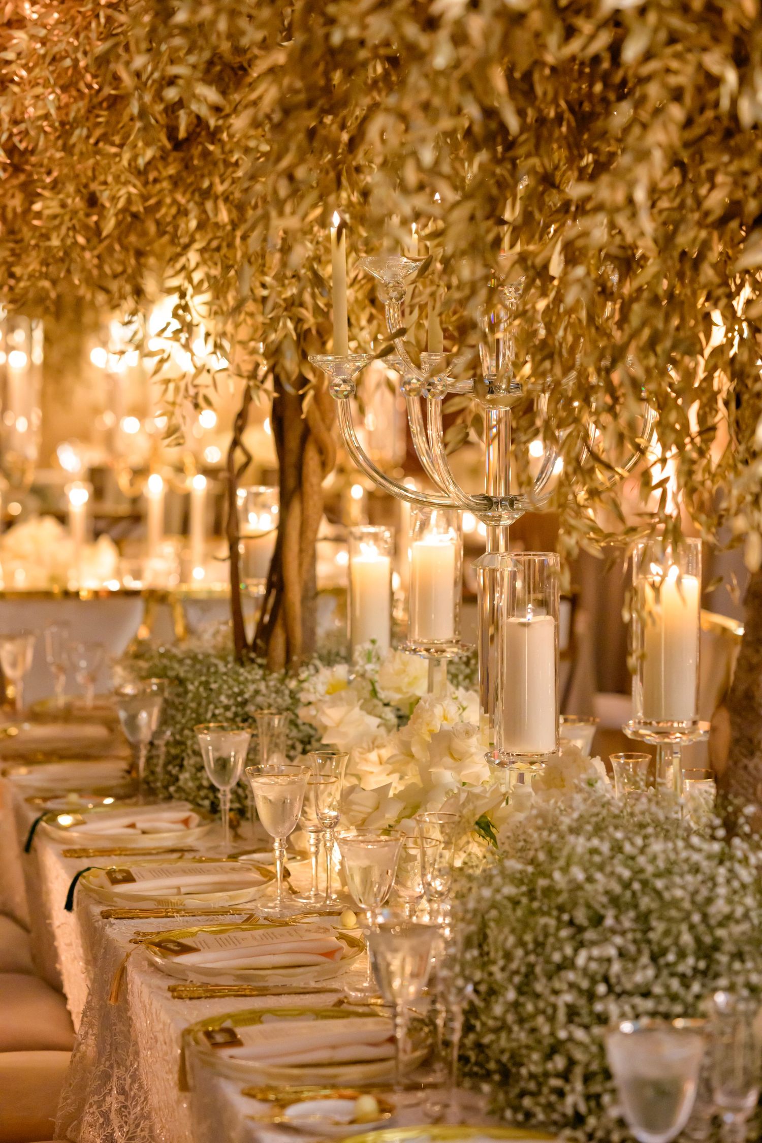 Romantic golden walkway lined with cascading florals.