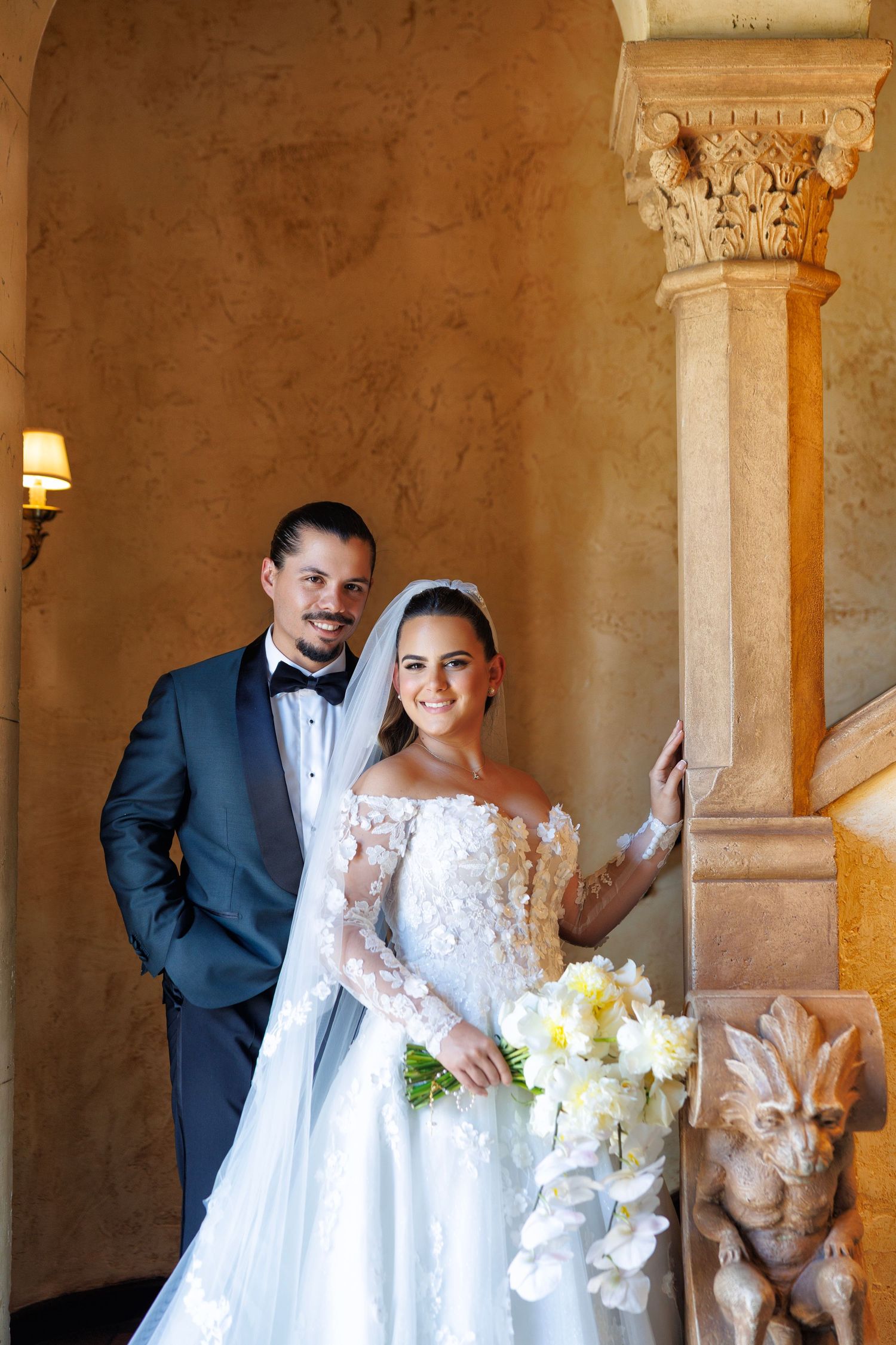 The couple poses with timeless elegance inside the grand venue.