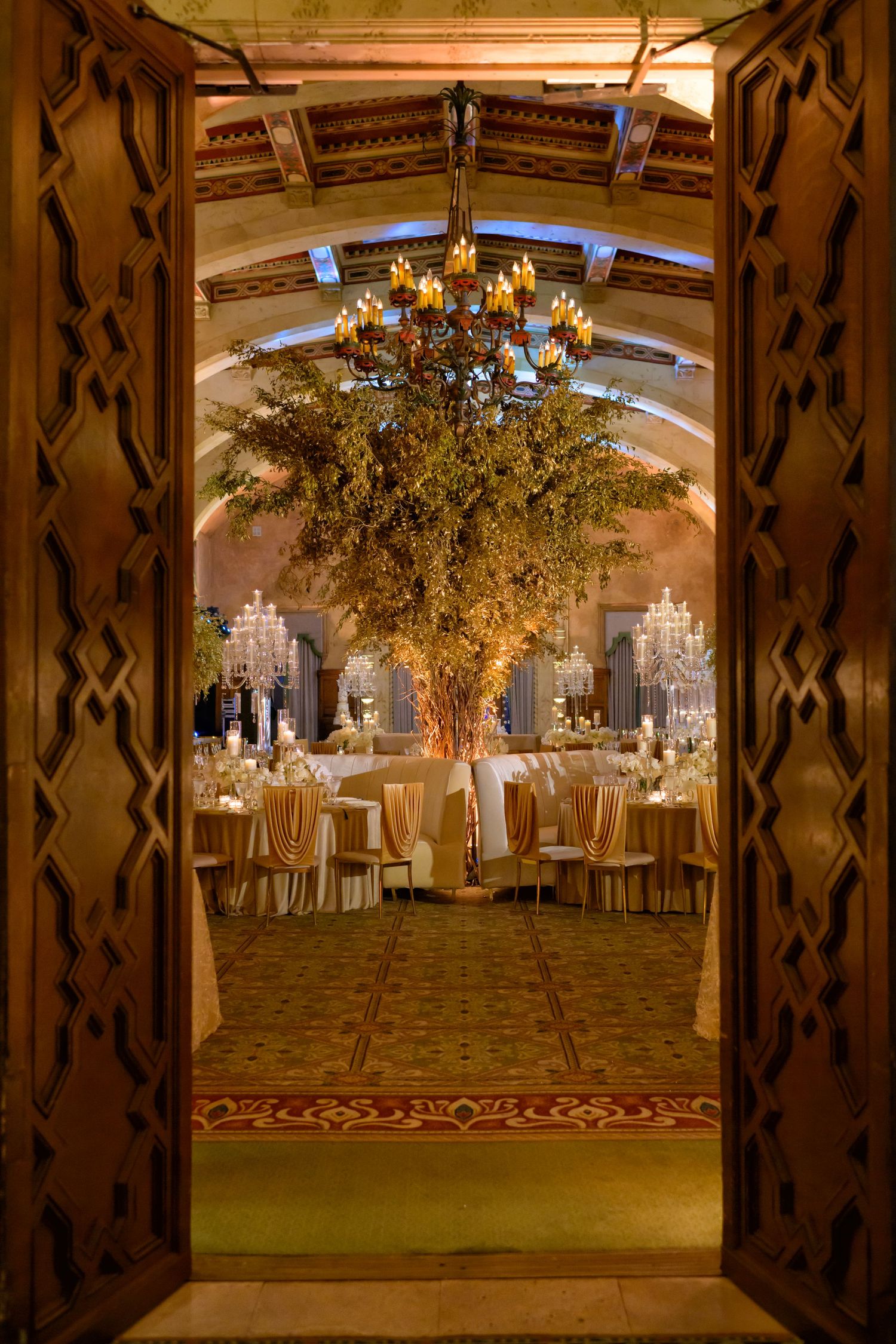 A peek through ornate doors reveals the breathtaking golden reception inside.