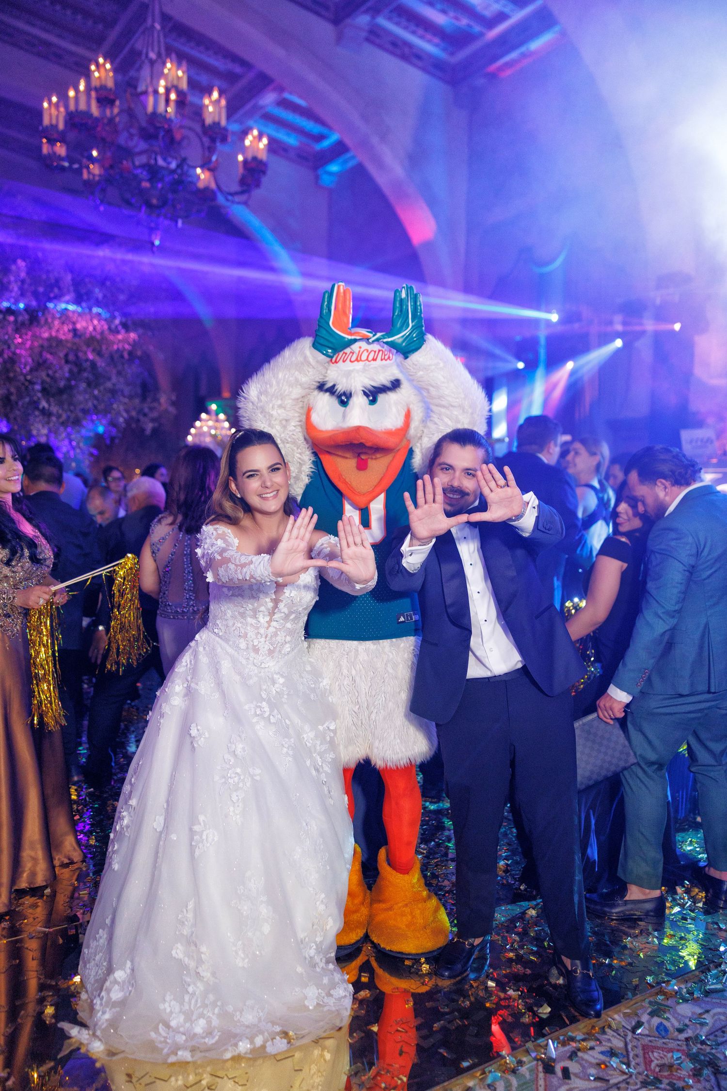 The bride and groom pose together with Sebastian the Ibis during their lively hora loca celebration.