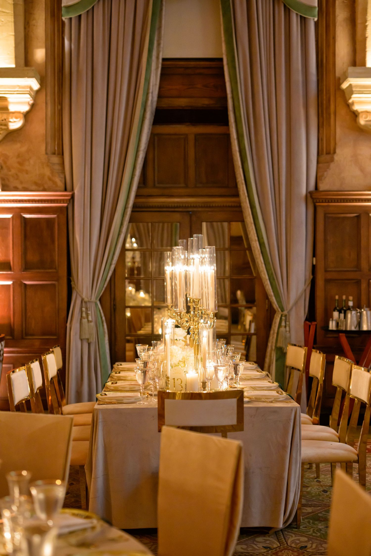 Candlelit table set for an intimate reception dinner.