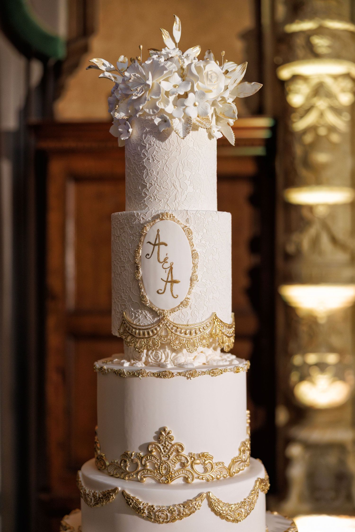 A towering white and gold wedding cake fit for royalty.