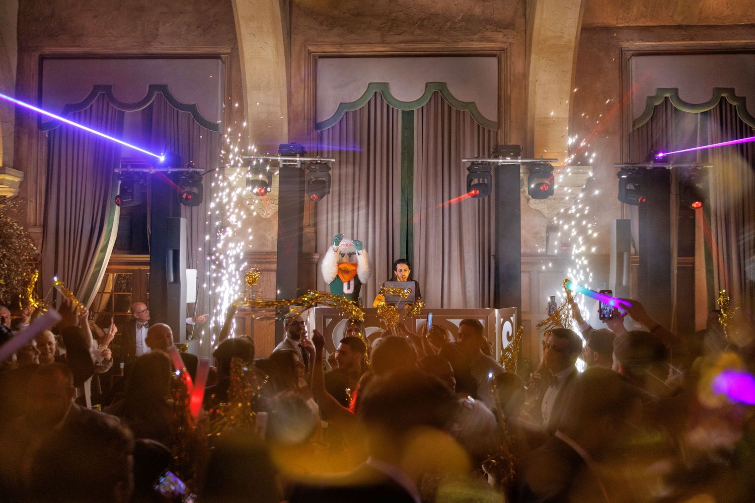 The reception entertainment in full swing, with performers on stage and the crowd energized under vibrant lighting.