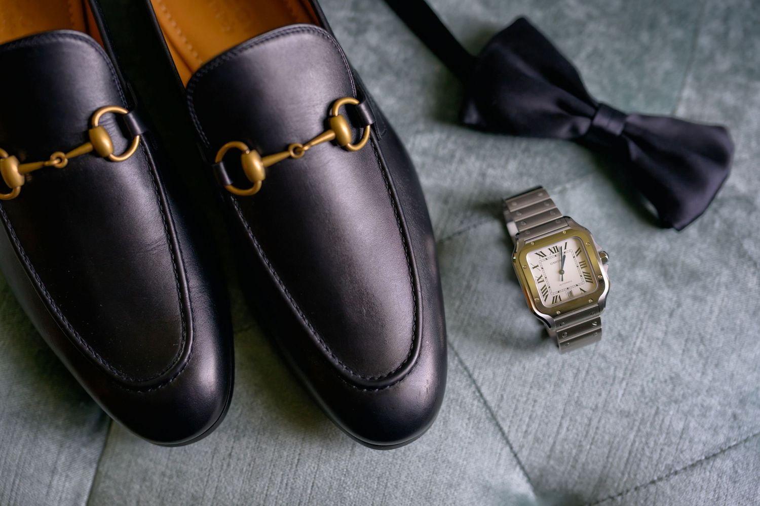 Sleek groom details: polished shoes, bow tie, and classic watch.