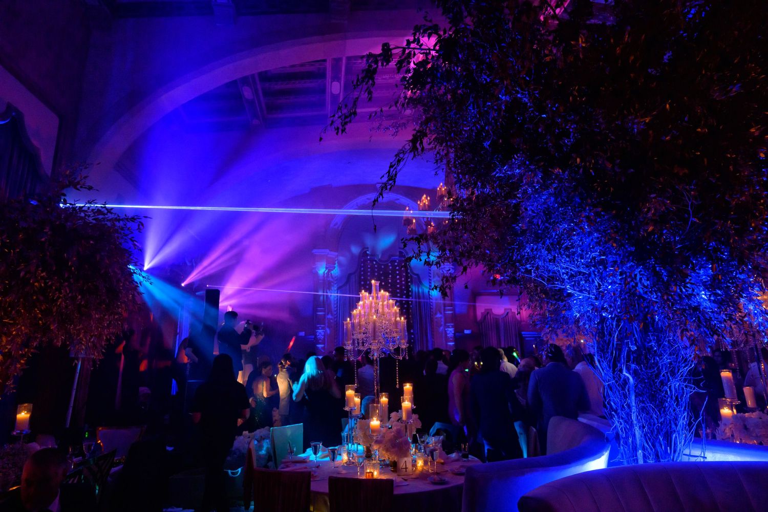 The reception glows with vibrant light, setting the scene for an unforgettable evening.