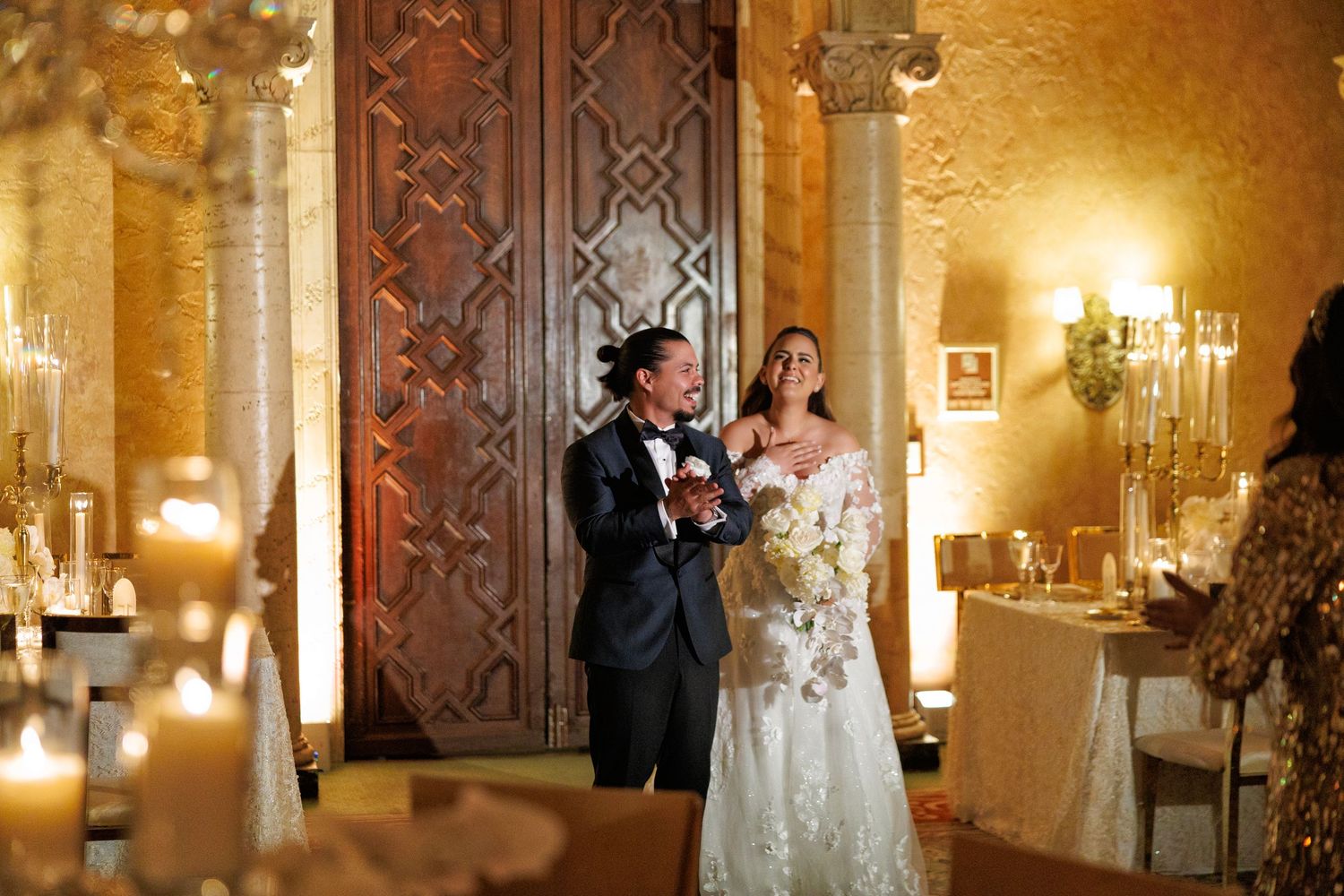 The newlyweds make their grand entrance surrounded by glowing candlelight.