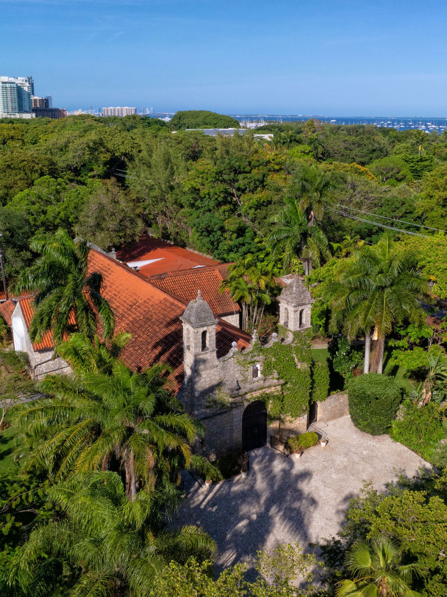 An aerial view of a historic Miami estate surrounded by tropical greenery, offering a glimpse of the venue’s timeless charm.