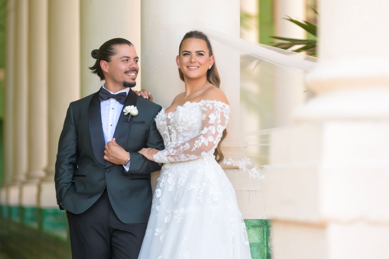Classic wedding portrait of the couple outdoors, exuding refined elegance and joy.