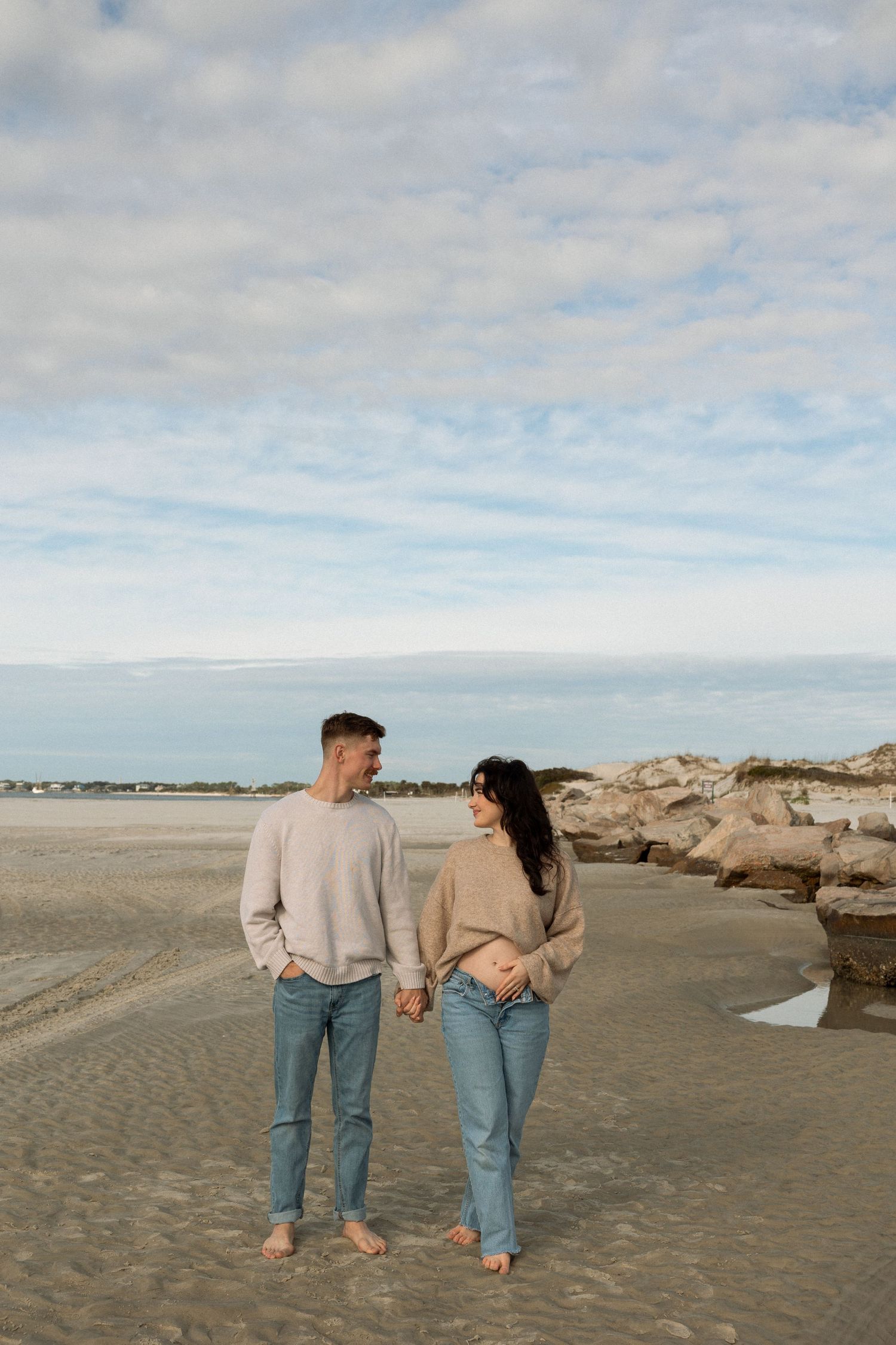 Beach pregnancy announcement session at sunset in Florida