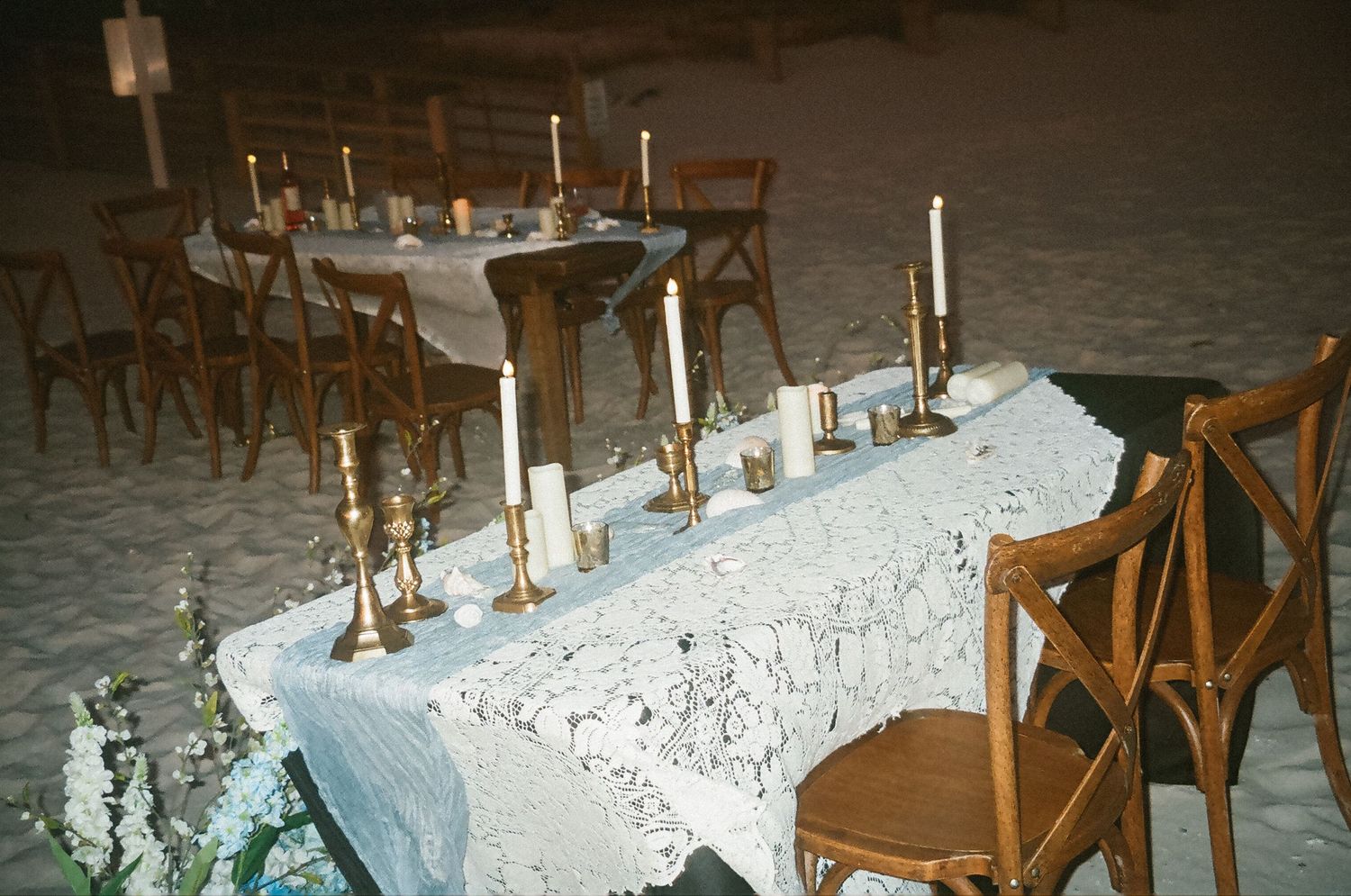 Film photograph of a wedding reception dinner table on the beach at sunset