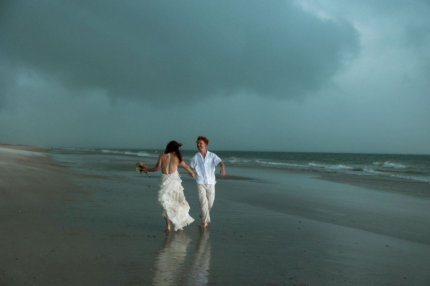 elopement on the beach during a storm in florida