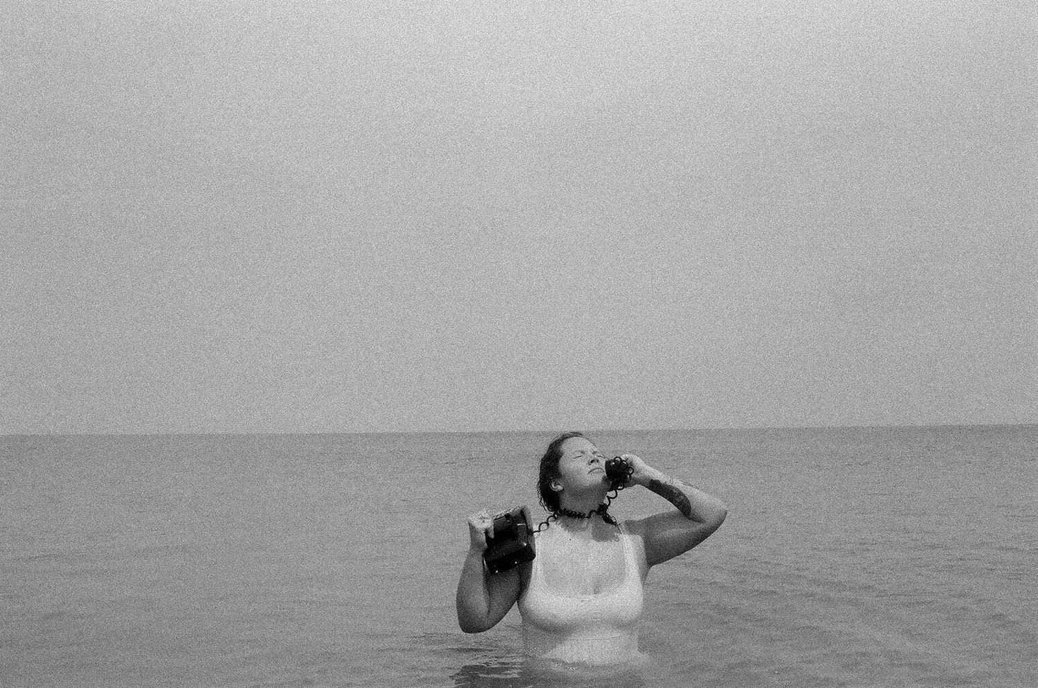 black and white film photo of girl swimming in Florida beach