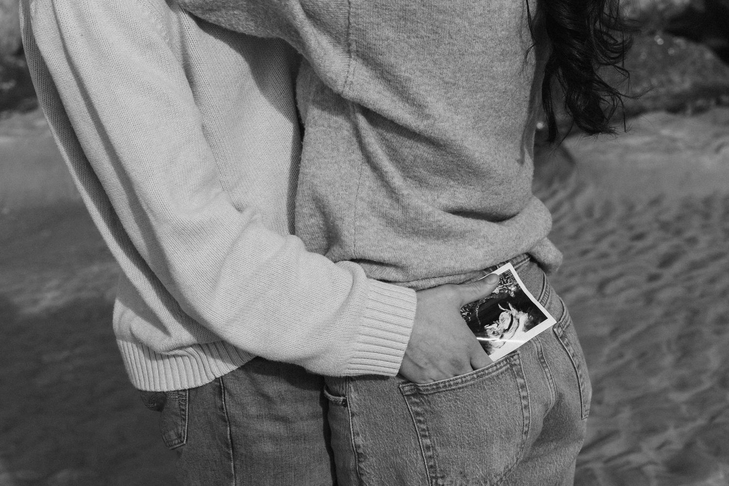 Black and white beach pregnancy announcement portrait