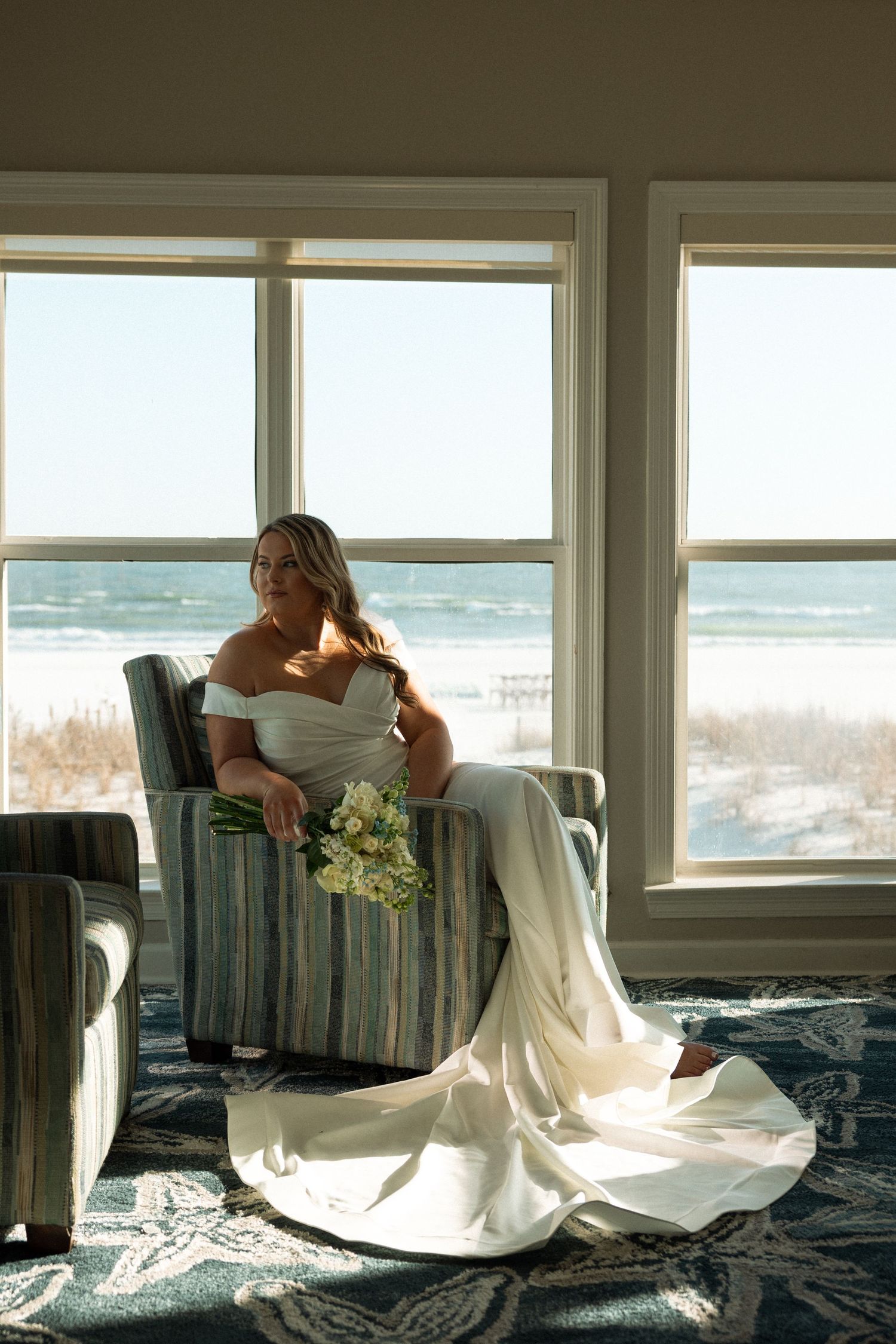 Bridal portrait seated in front of a window with natural light