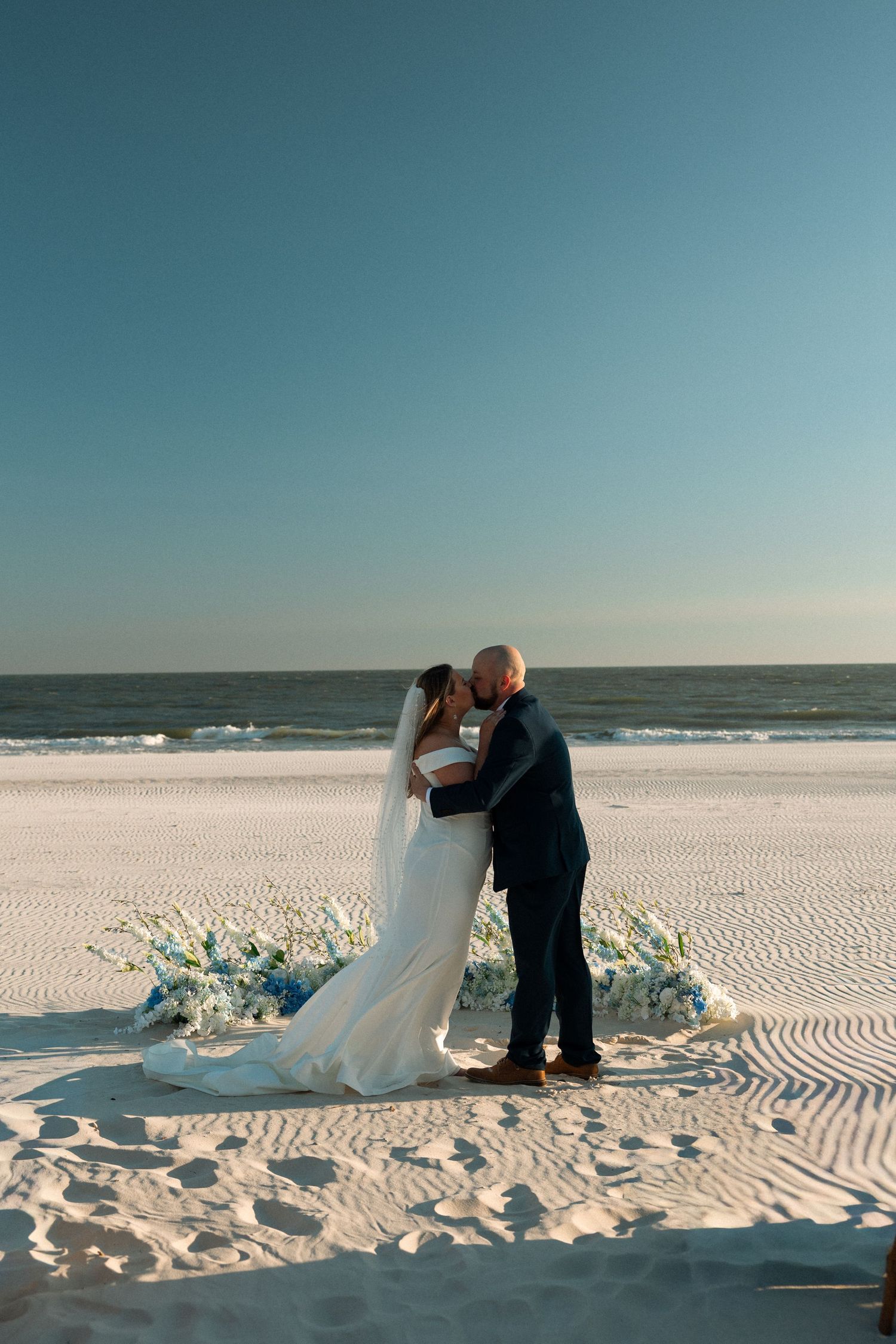 First kiss during a beachfront micro wedding in Alabama
