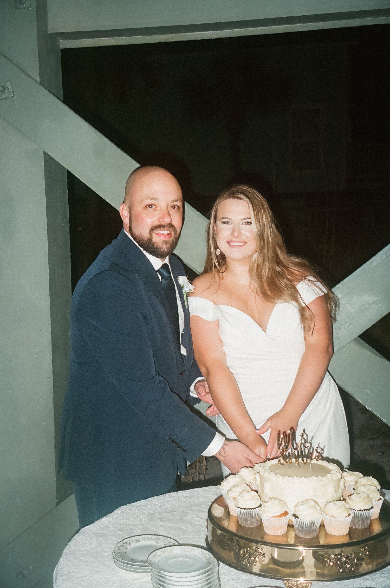 Flash film photograph of bride and groom cutting their wedding cake