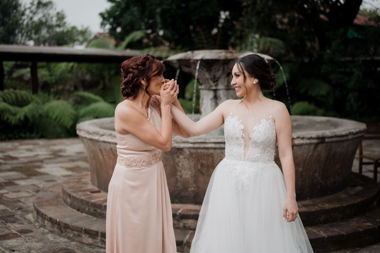 Intimate moment of wedding preparation with final makeup touches outdoors.