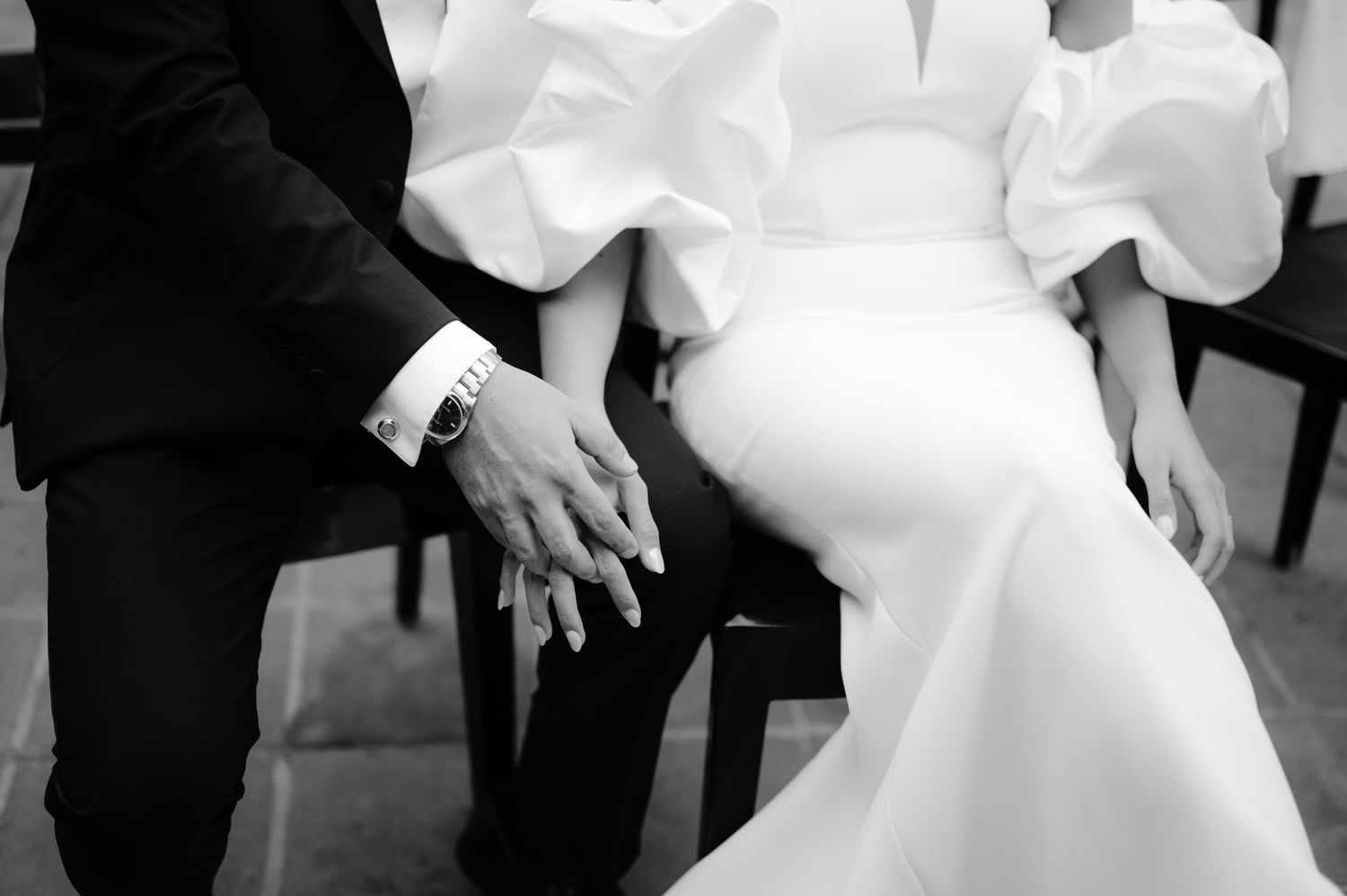 Close up of wedding couple's elegant formal attire in black and white.