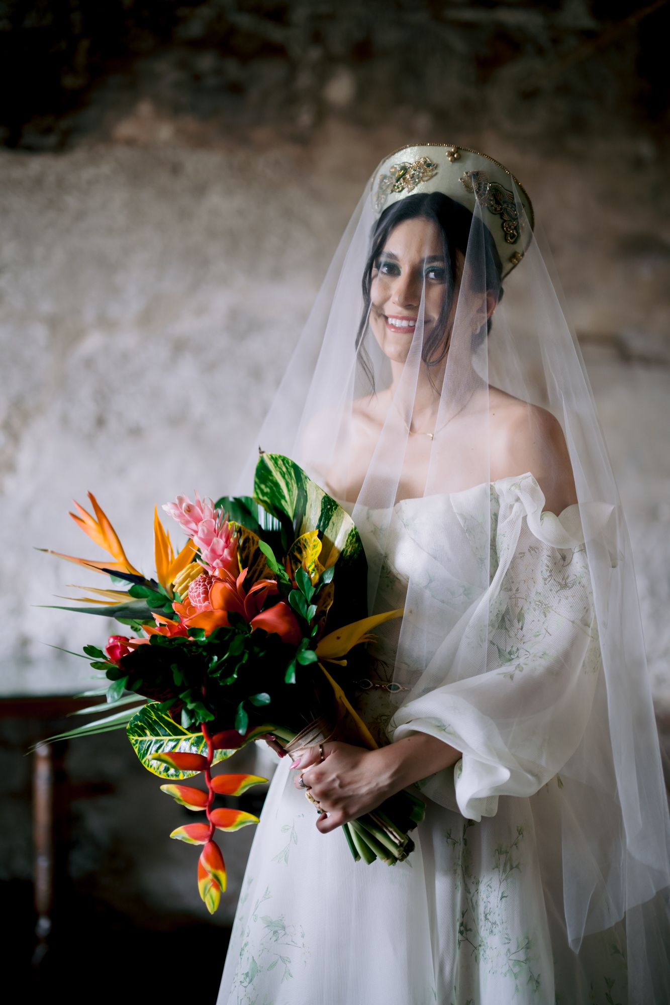 Elegant bridal portrait with a tropical bouquet featuring birds of paradise and bright florals.