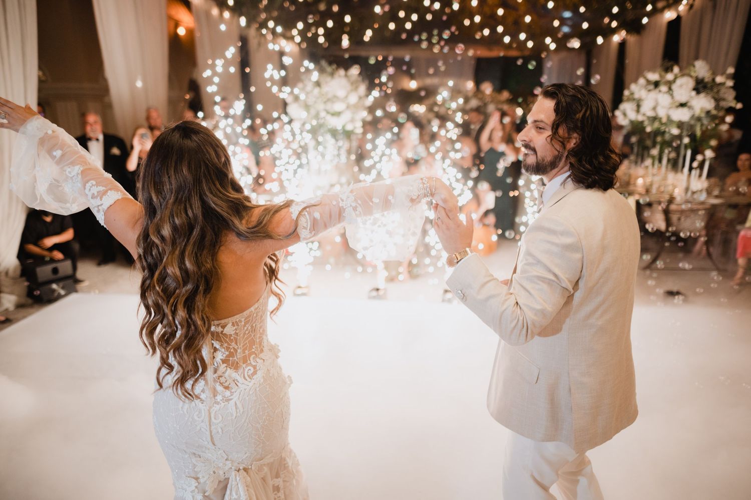 Wedding reception celebration with twinkling string lights and confetti creating a magical atmosphere.
